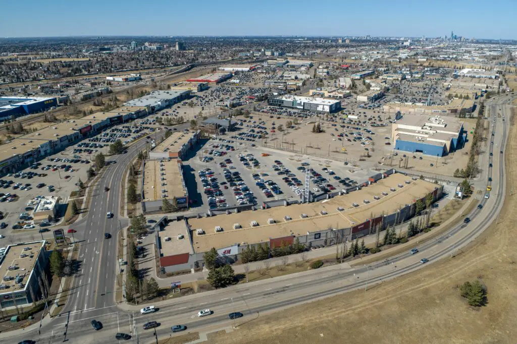 Aerial photo of South Edmonton Common with the city of Edmonton skyline in the background.